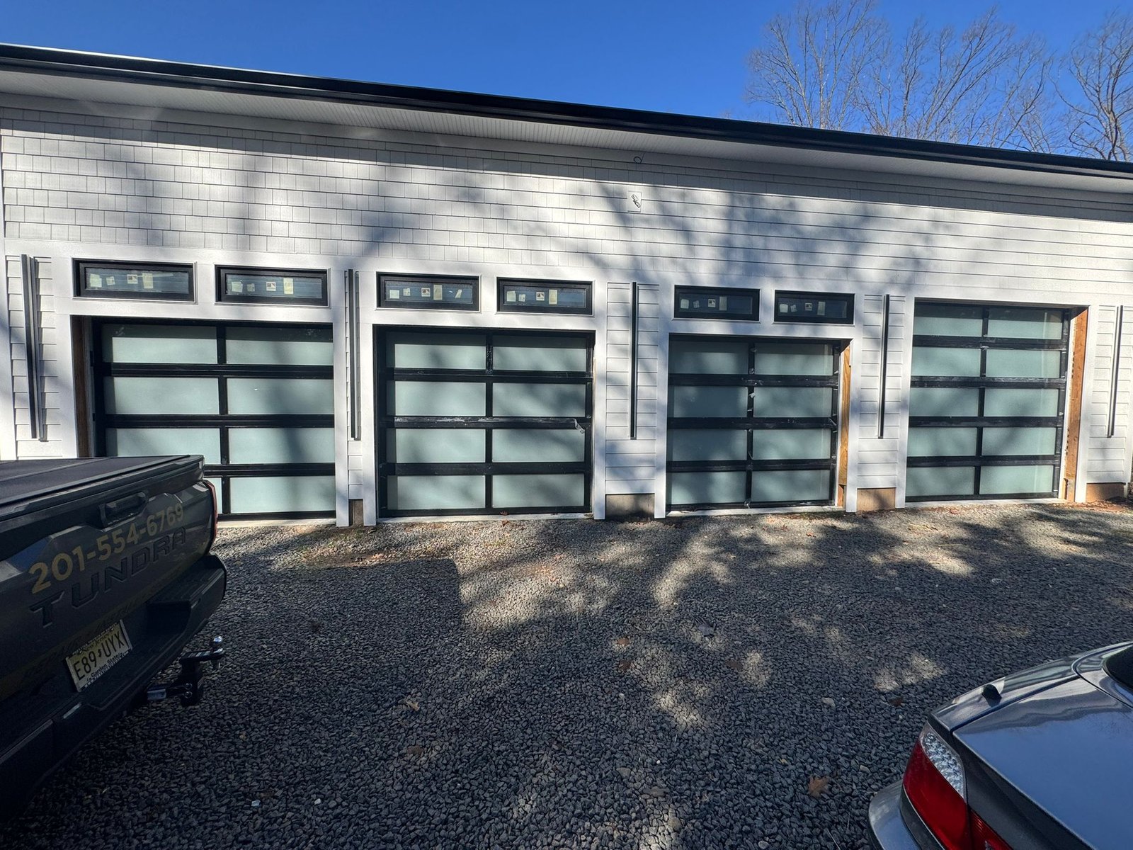 New Door Installation - Premium 4-Bay Frosted Glass Commercial Installation in Wayne completed in Wayne, NJ, NJ by Ez2Fix Garage Door Repair